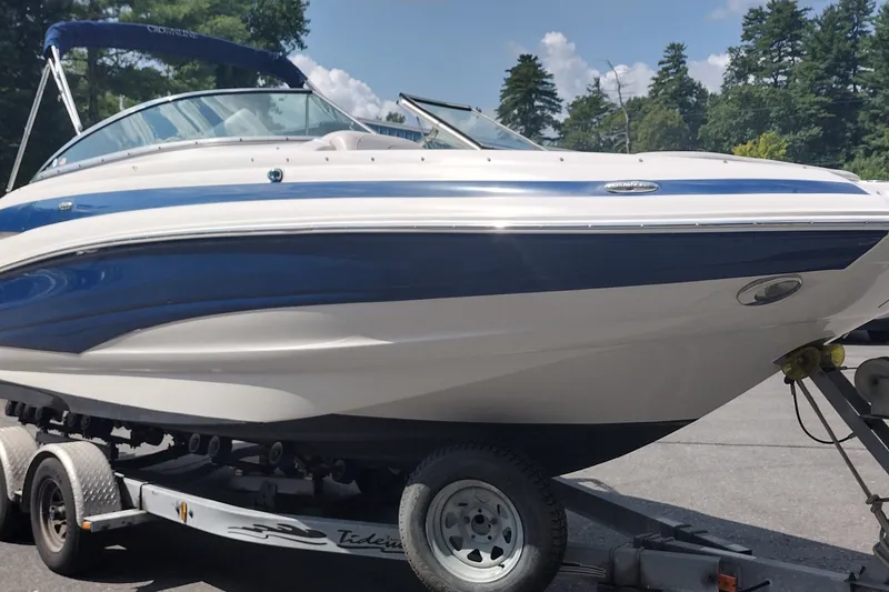 Slide: The Image of 2013 Crownline Eclipse E4 boat on trailer, featuring sleek design and blue accents. - 4