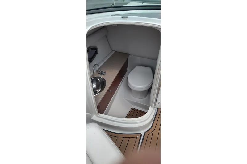 Slide: The Image of 2013 Crownline Eclipse E4 boat interior with compact bathroom and sink. - 22