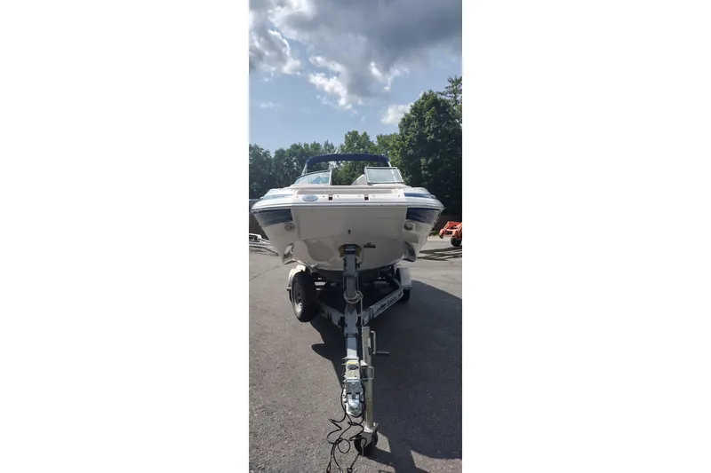 Slide: The Image of 2013 Crownline Eclipse E4 boat on trailer under cloudy sky. - 3