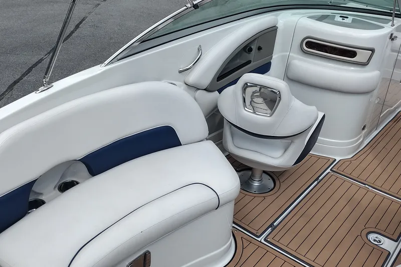 Slide: The Image of 2013 Crownline Eclipse E4 boat interior with white seating and wood-style flooring. - 11