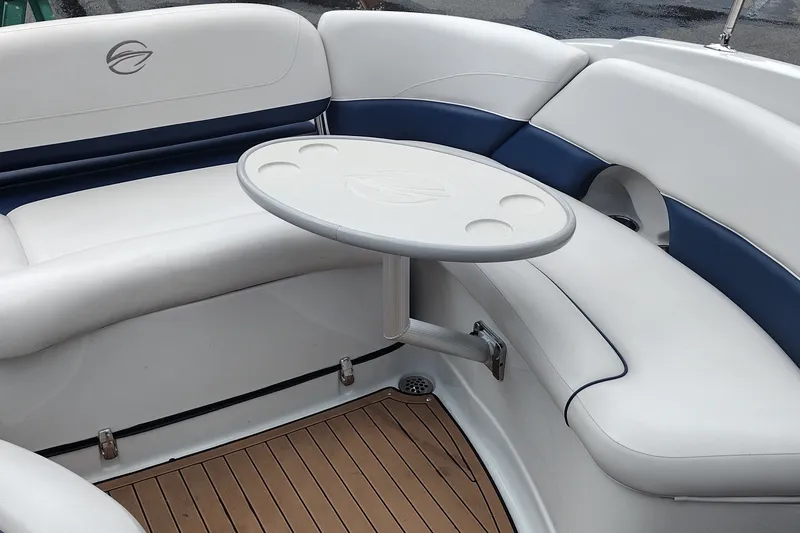 Slide: The Image of 2013 Crownline Eclipse E4 boat interior with white and blue seating and a round table. - 31