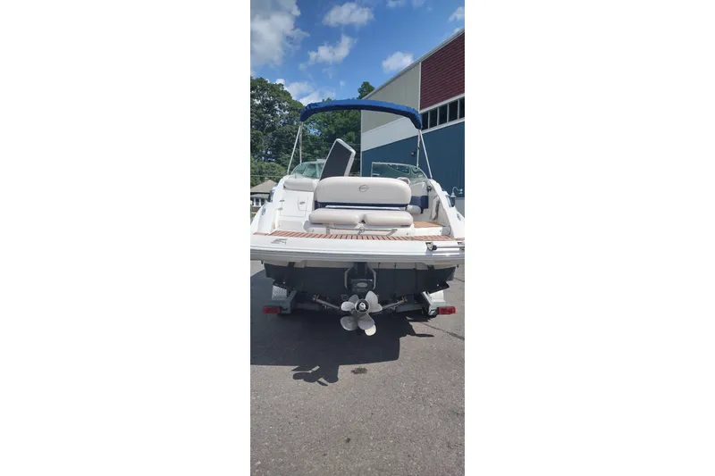 Slide: The Image of 2013 Crownline Eclipse E4 boat, rear view, parked outdoors under blue sky. - 9