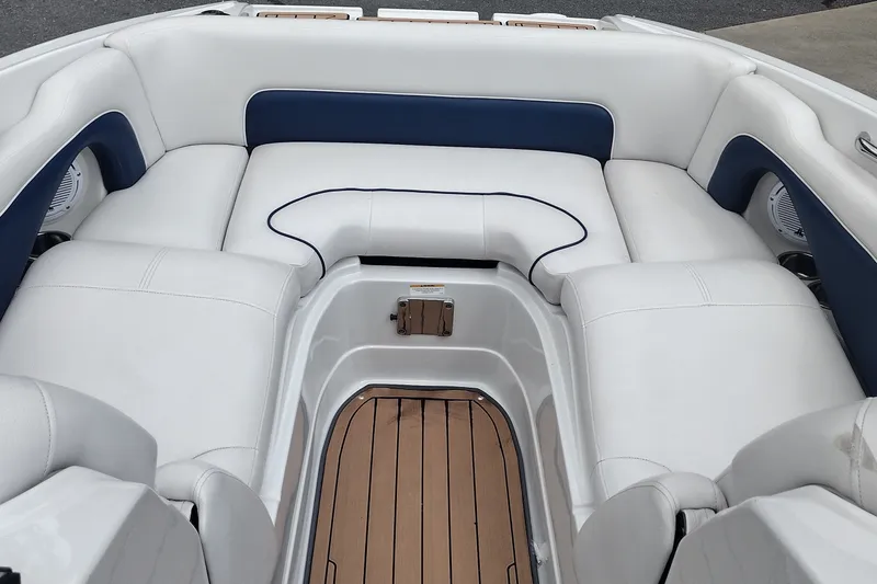 Slide: The Image of 2013 Crownline Eclipse E4 boat interior with white and blue seating, teak flooring. - 12