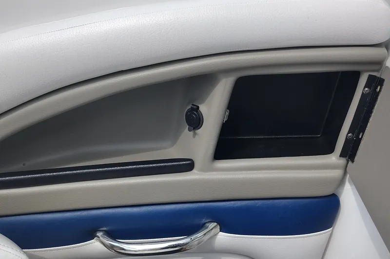 Slide: The Image of Interior detail of a 2013 Crownline Eclipse E4 boat, featuring storage compartment and handle. - 42