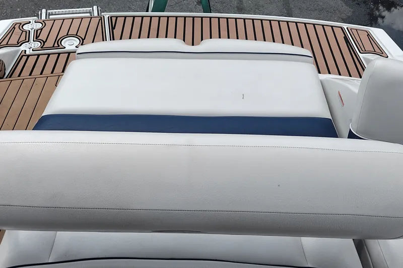 Slide: The Image of 2013 Crownline Eclipse E4 boat interior with white and blue seating, teak flooring. - 41