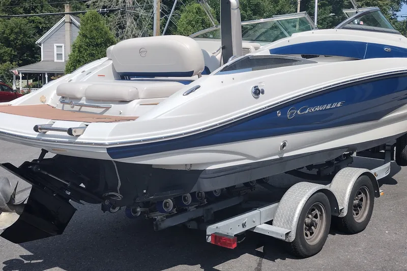 Slide: The Image of 2013 Crownline Eclipse E4 boat on trailer, parked outdoors. - 6