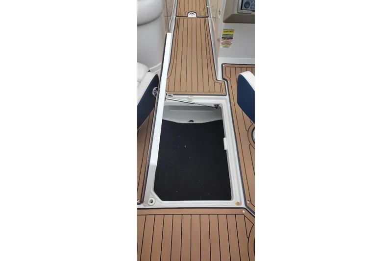 Slide: The Image of 2013 Crownline Eclipse E4 boat deck with open storage compartment. - 37