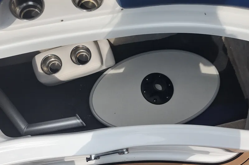 Slide: The Image of Storage compartment in a 2013 Crownline Eclipse E4 boat with cup holders and table. - 32