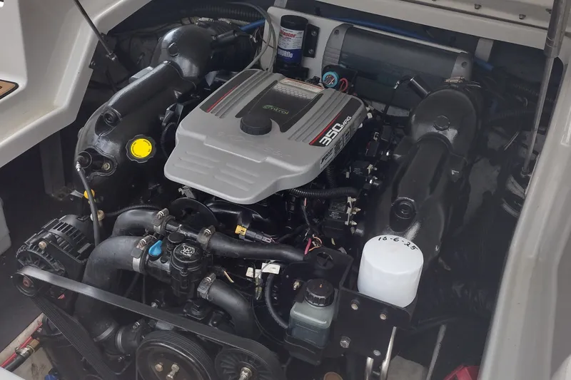 Slide: The Image of Engine compartment of a 2013 Crownline Eclipse E4 boat, featuring a 350 MAG engine. - 26