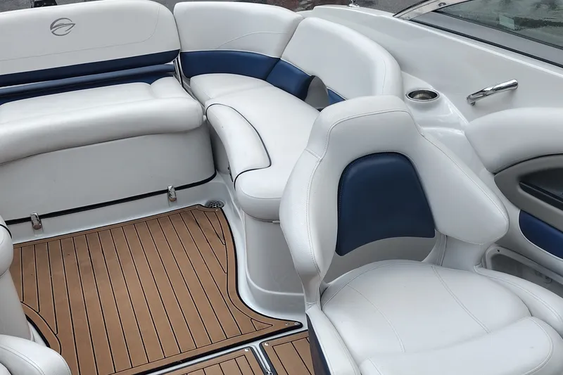 Slide: The Image of 2013 Crownline Eclipse E4 boat interior with white and blue seating, teak-style flooring. - 15