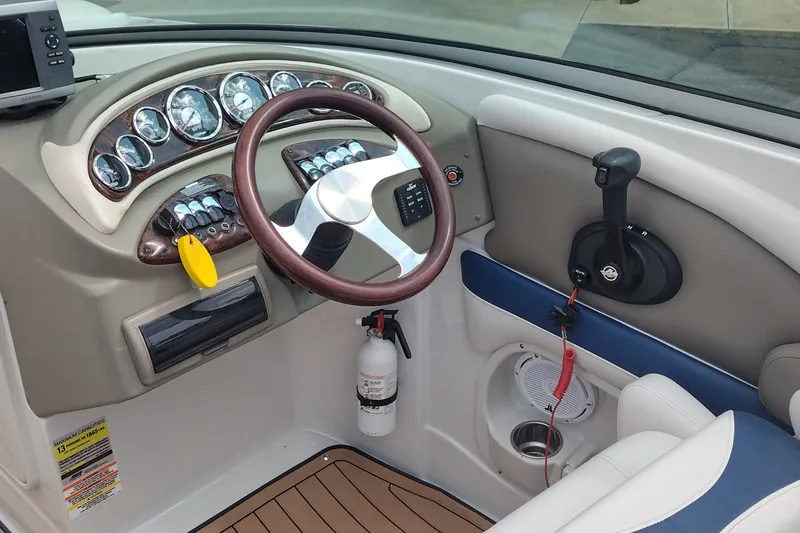Slide: The Image of 2013 Crownline Eclipse E4 boat dashboard with steering wheel and control panel. - 18
