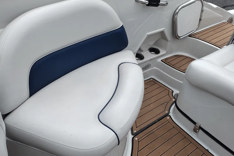Slide: The Image of 2013 Crownline Eclipse E4 boat interior with white and blue seating, teak-style flooring. - 24
