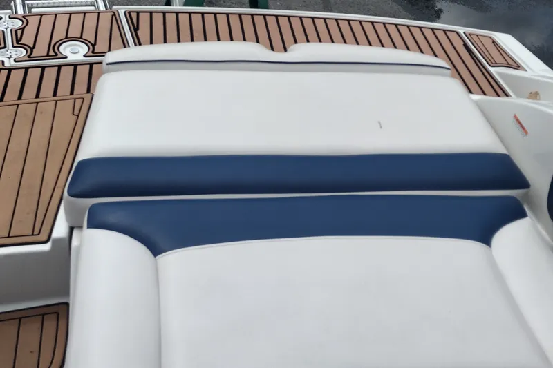 Slide: The Image of 2013 Crownline Eclipse E4 boat with white and blue cushioned seating. - 39