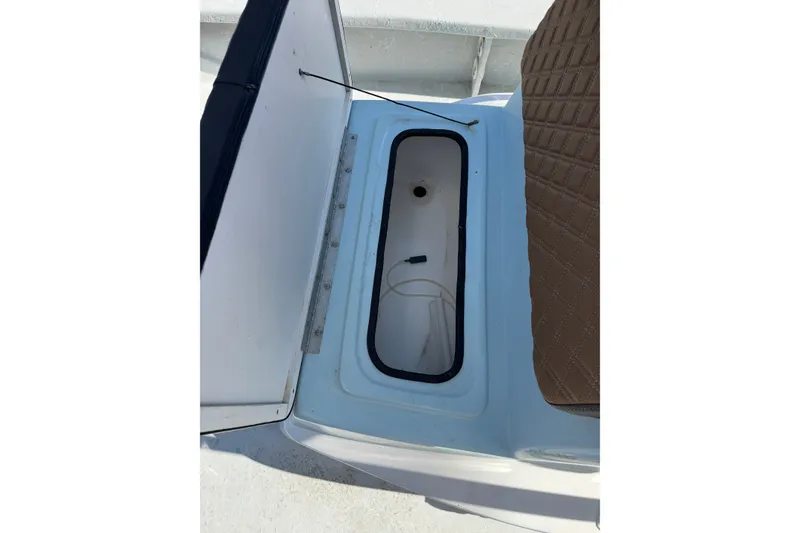 Slide: The Image of Open storage compartment on 2021 Haynie 25 Magnum boat with brown seat detail. - 15
