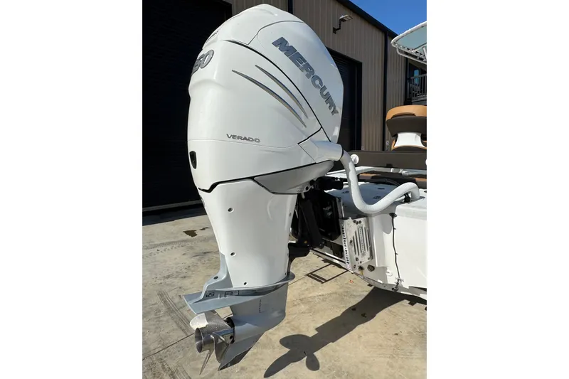 Slide: The Image of 2021 Haynie 25 Magnum boat with Mercury Verado outboard motor in a sunny setting. - 18