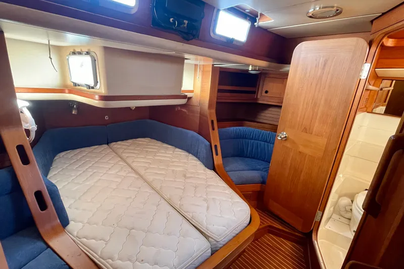 Slide: The Image of Cozy cabin interior of 1986 Baltic 48 DP yacht with wooden finishes and comfortable bedding. - 23