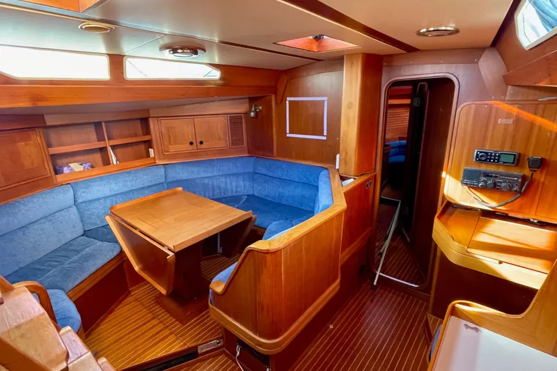 Slide: The Image of Interior of 1986 Baltic 48 DP yacht with wooden finish and blue seating. - 16