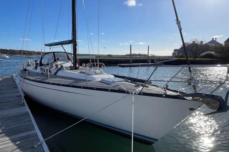 Slide: The Image of 1986 Baltic 48 DP sailboat docked in a sunny marina setting. - 5