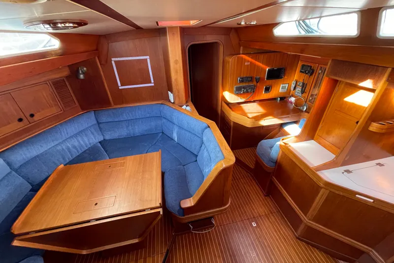 Slide: The Image of Interior of 1986 Baltic 48 DP yacht with blue seating and wooden finishes. - 18