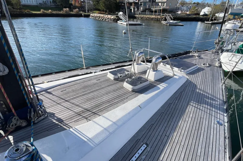 Slide: The Image of 1986 Baltic 48 DP sailboat deck with marina view, showcasing sleek design and craftsmanship. - 13