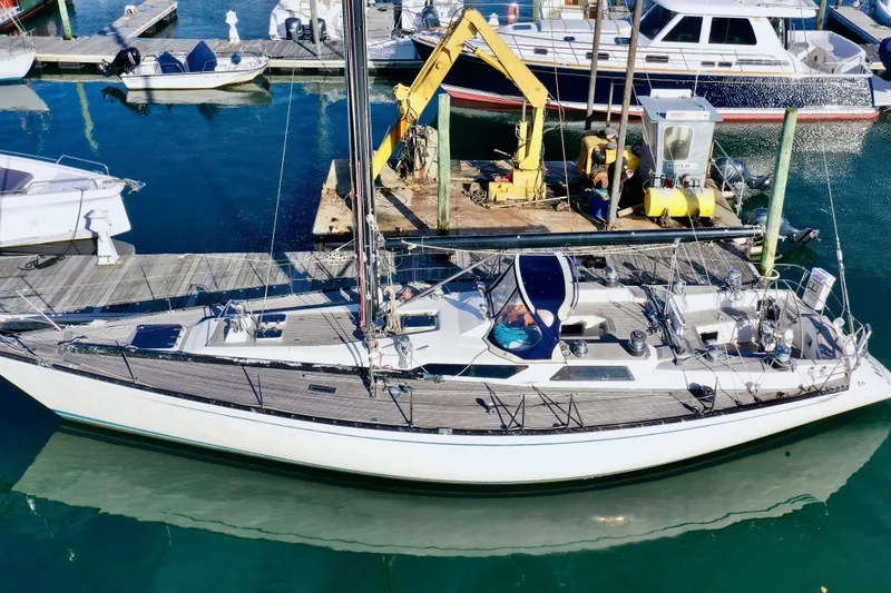 Slide: The Image of Baltic 48 DP sailboat from 1986 docked at a marina with clear blue water. - 4