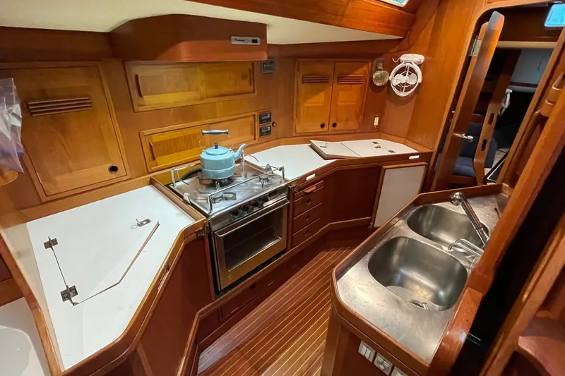 Slide: The Image of Luxurious 1986 Baltic 48 DP yacht kitchen with wooden cabinetry and modern appliances. - 21