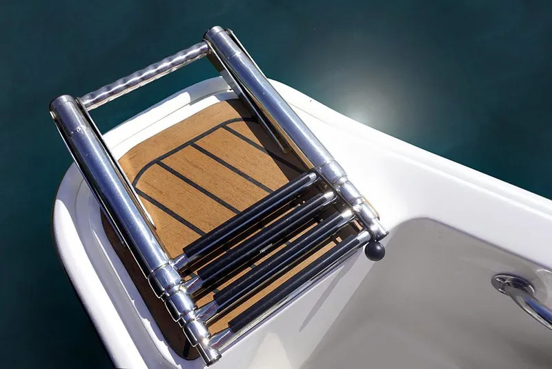 Slide: The Image of Manufacturer Provided Image: Stainless steel ladder on 2025 Boston Whaler 130 Super Sport boat. - 14