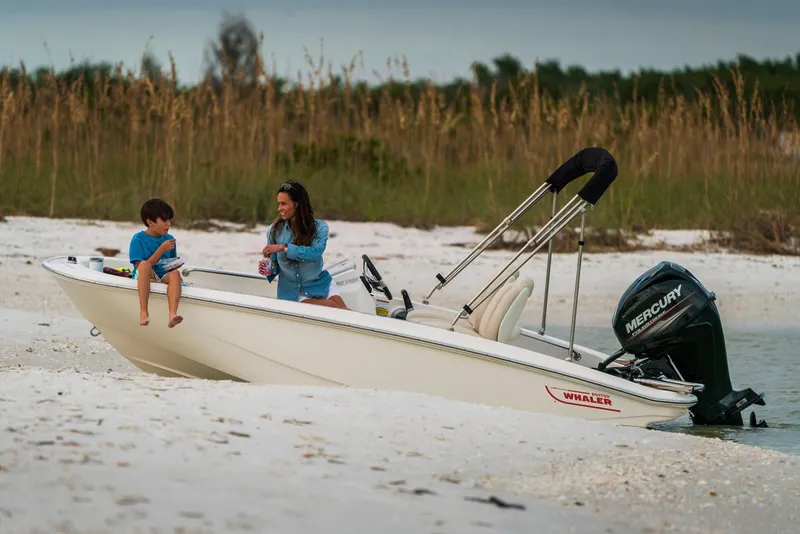Slide: The Image of Manufacturer Provided Image: 2025 Boston Whaler 130 Super Sport on sandy beach with two people. - 0