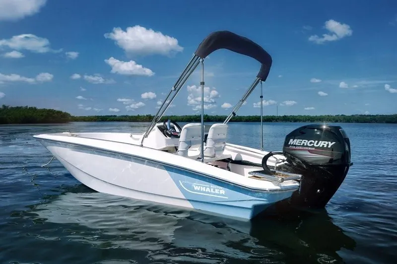 Slide: The Image of Manufacturer Provided Image: 2025 Boston Whaler 130 Super Sport boat on a calm lake under a clear blue sky. - 4