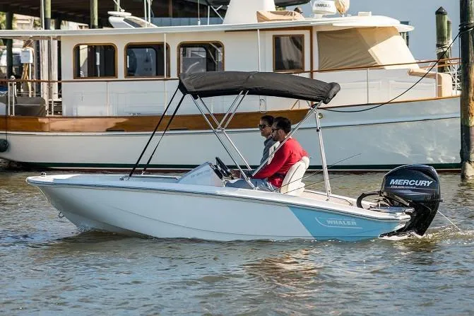 Slide: The Image of Manufacturer Provided Image: 2025 Boston Whaler 130 Super Sport boat cruising on water with Mercury engine. - 2
