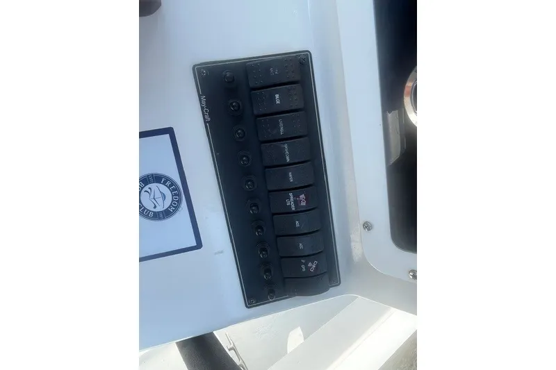 Slide: The Image of Control panel of a 2022 May-Craft 2300CC boat with labeled switches. - 5