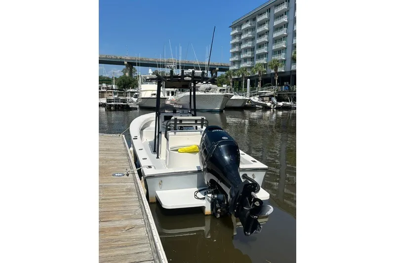 Slide: The Image of 2022 May-Craft 2300CC boat docked at marina with outboard motor. - 3