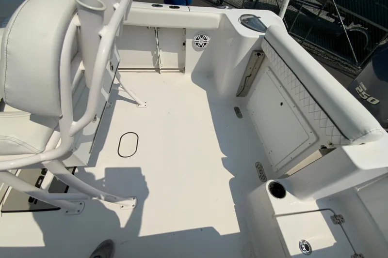 Slide: The Image of 2023 Sportsman Open 232 Center Console boat interior with seating and storage compartments. - 17