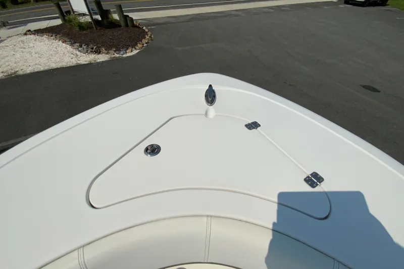 Slide: The Image of 2023 Sportsman Open 232 Center Console boat bow view, showcasing sleek design and storage compartments. - 25