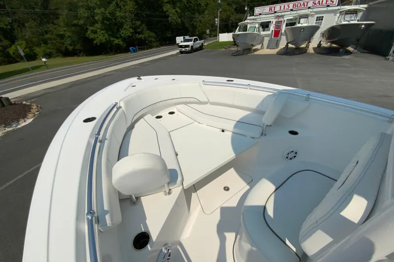 Slide: The Image of 2023 Sportsman Open 232 Center Console boat at dealership, showcasing spacious seating area. - 20