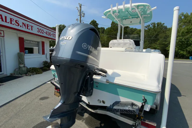 Slide: The Image of 2023 Sportsman Open 232 Center Console boat with Yamaha 250 engine, parked outside dealership. - 9