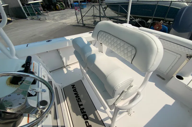 Slide: The Image of 2023 Sportsman Open 232 Center Console boat interior with white seating and steering wheel. - 15