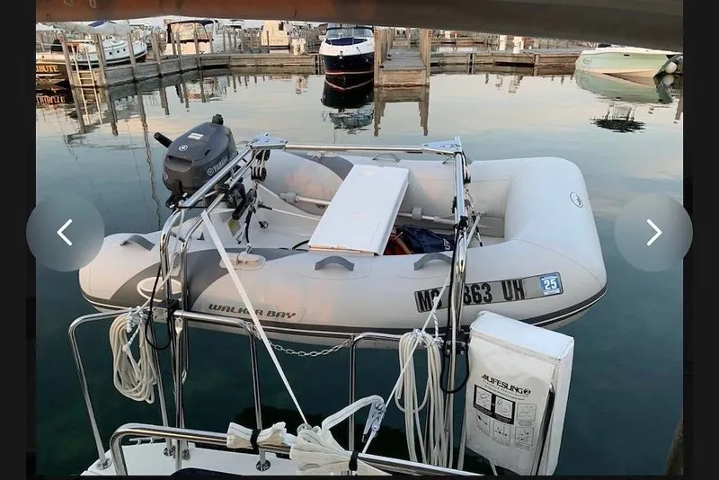 Slide: The Image of Inflatable dinghy with Yamaha motor docked near Ranger Tugs R-27, 2015 model. - 45