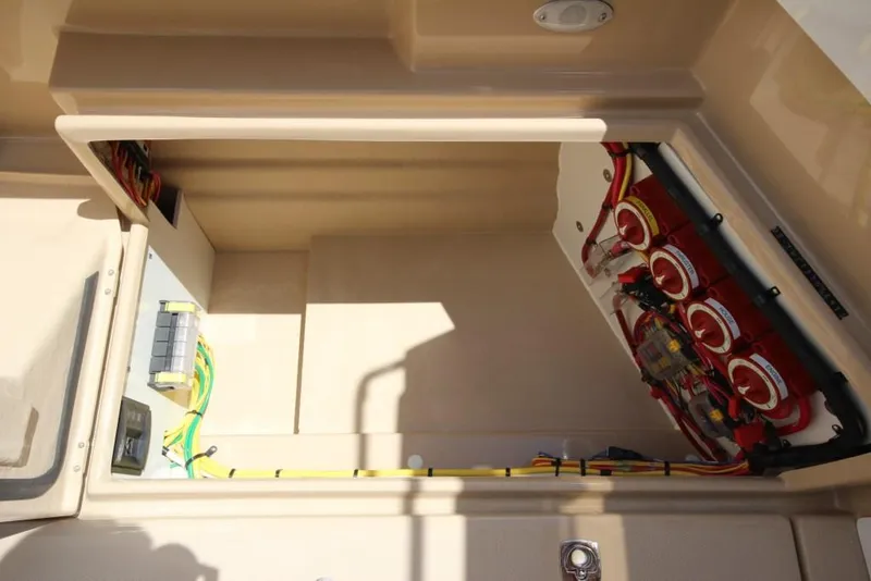 Slide: The Image of An open compartment in the boat reveals electrical wiring and fuses. - 22