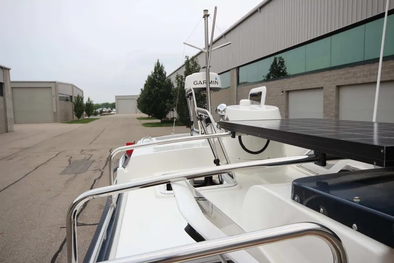 Slide: The Image of 2015 Ranger Tugs R-27 boat with solar panel and Garmin equipment, parked near industrial buildings. - 51