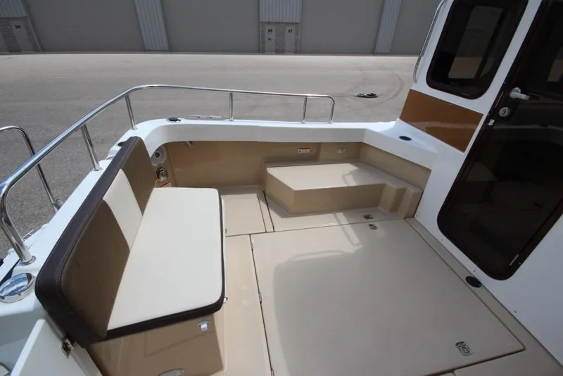 Slide: The Image of The image shows the cockpit of a 2015 Ranger Tugs R-27 with seating and steps. - 13