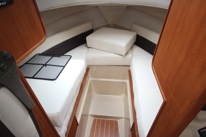 Slide: The Image of Interior cabin of 2015 Ranger Tugs R-27 with cushioned seating and wooden accents. - 48