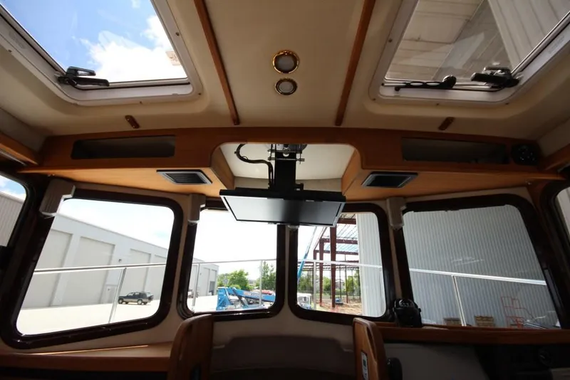 Slide: The Image of Interior view of a Ranger Tugs R-27 cabin with large windows and skylights. - 27