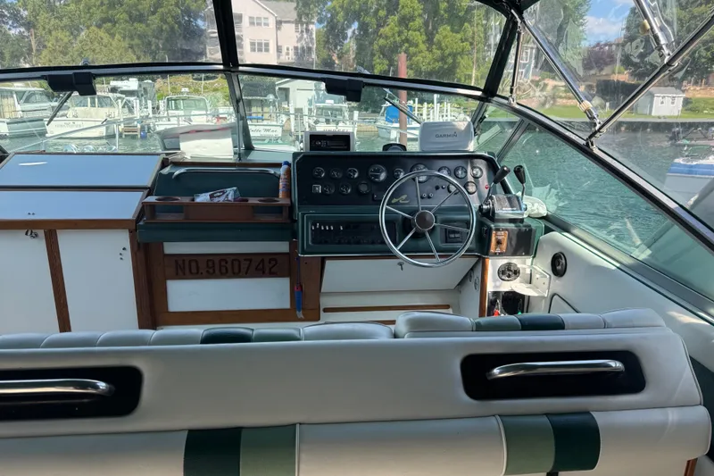 Slide: The Image of Cockpit of 1989 Sea Ray 300 Sundancer boat with steering wheel and control panel. - 23