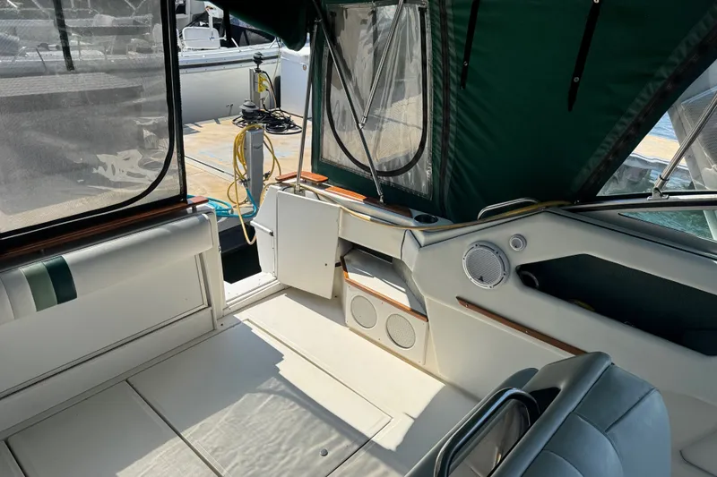 Slide: The Image of Interior of 1989 Sea Ray 300 Sundancer boat with green canopy and seating area. - 20
