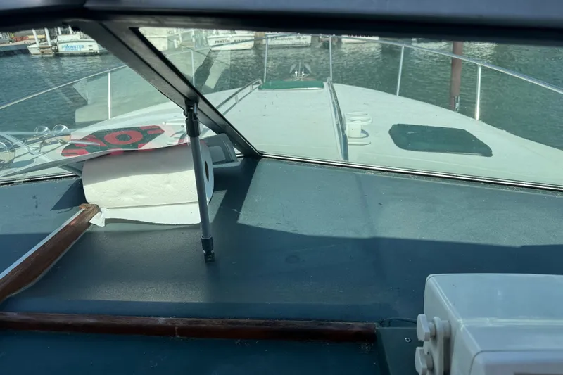 Slide: The Image of 1989 Sea Ray 300 Sundancer boat interior with marina view through windshield. - 19