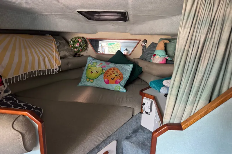 Slide: The Image of Cozy cabin interior of 1989 Sea Ray 300 Sundancer with colorful pillows and decor. - 18
