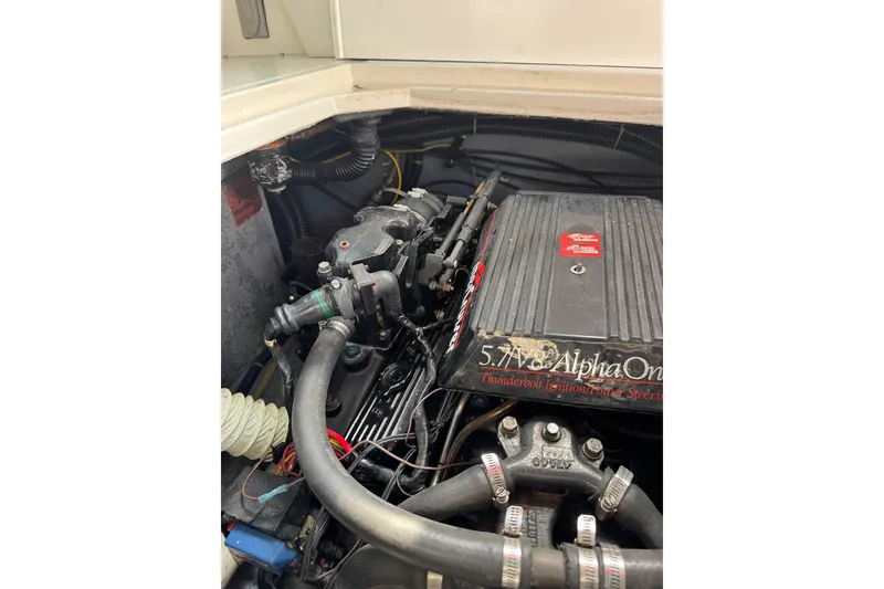 Slide: The Image of Engine compartment of a 1989 Sea Ray 300 Sundancer boat, featuring a 5.7L V8 Alpha One engine. - 7