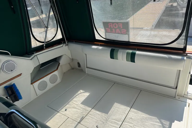 Slide: The Image of 1989 Sea Ray 300 Sundancer interior with green accents, for sale sign visible. - 21