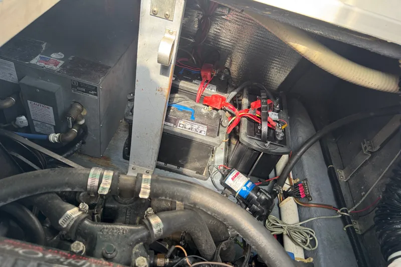 Slide: The Image of Engine compartment of a 1989 Sea Ray 300 Sundancer with visible batteries and wiring. - 8